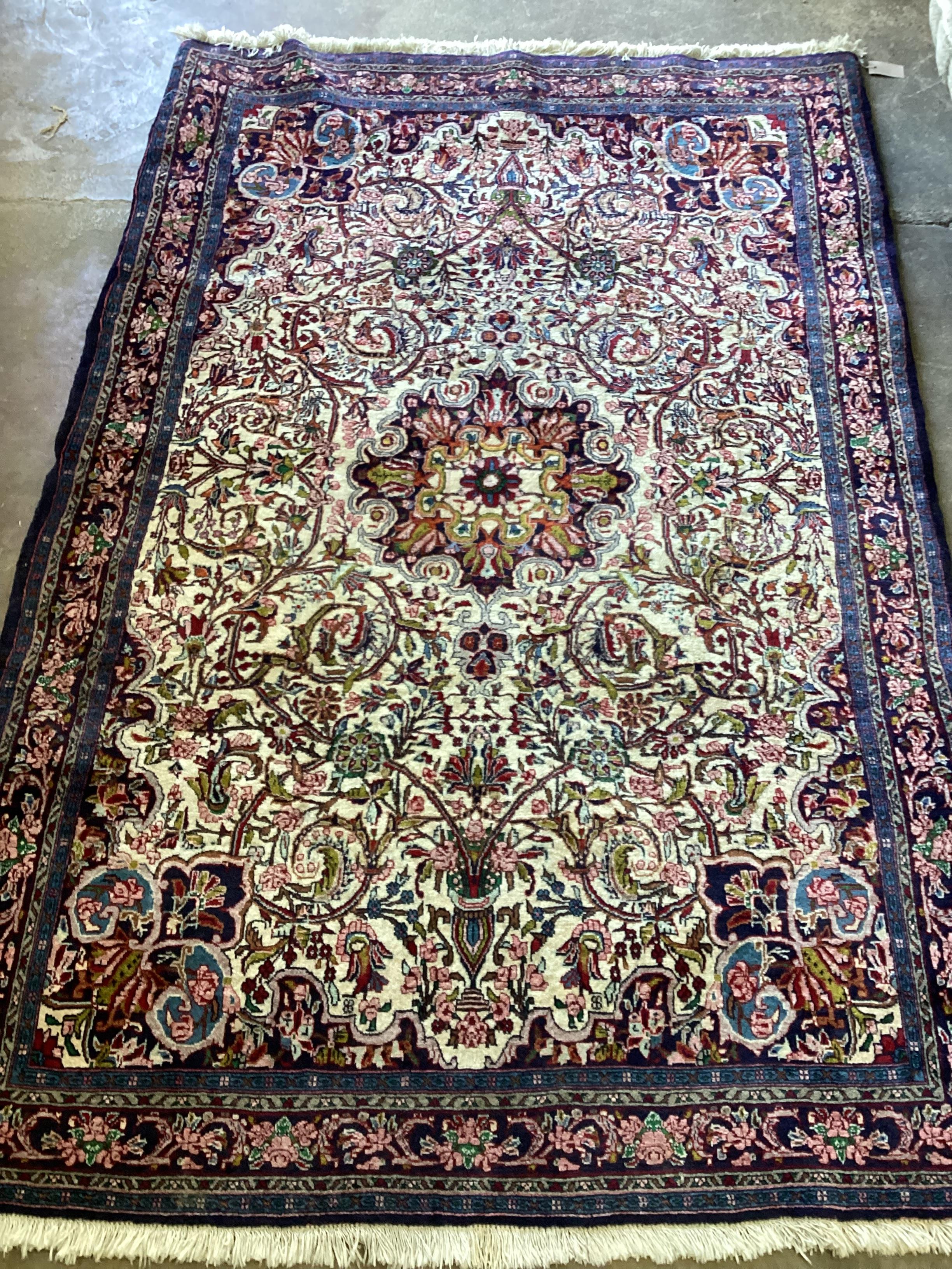 A North West Persian part silk ivory ground rug, 202cm x 138cm